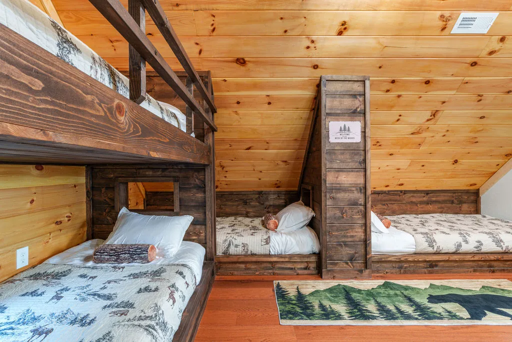 Additional twin XL beds in the bunk room with a dresser between them
