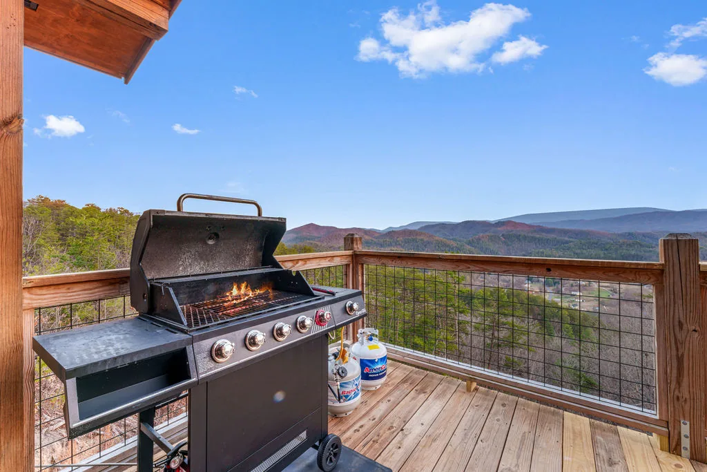 Gas grill on the deck with the mountain range in the background