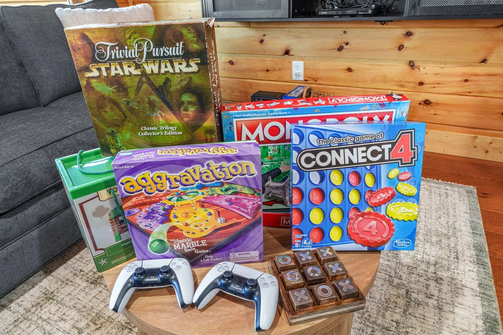 Stack of board games and game controllers provided in the game room